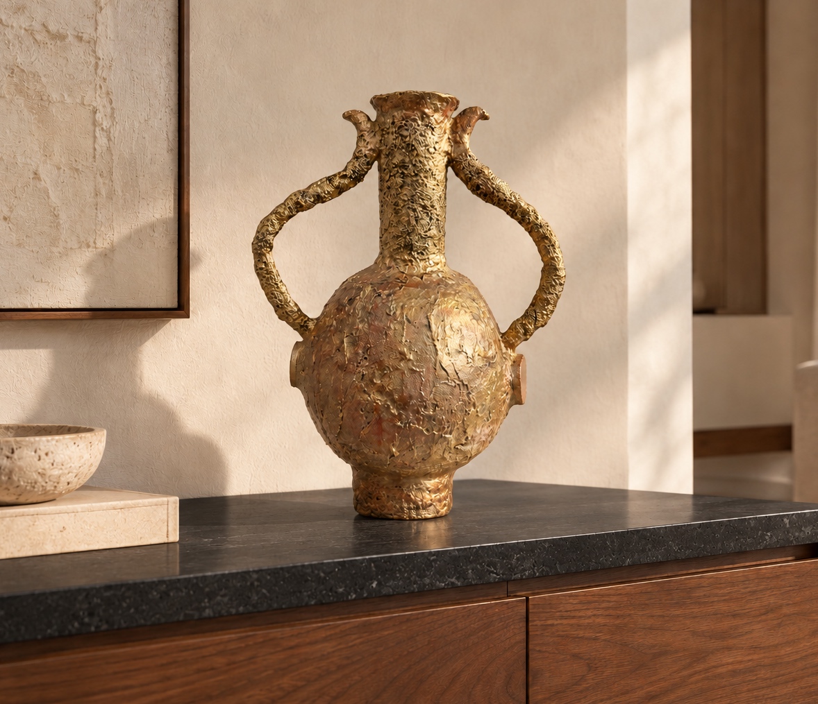 Gilded Vase — a tall gilded papier-mâché vessel with sculpted handles.